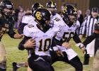 Quarterback Ethan Dorman rushed for 187 yards as the Clearbrook-Gonvick Bears won over Kittson County Central. Helping to block the way is senior Judah Bennett.