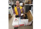 Chris Eck, a member of the Gonvick Lions Club, taking 477 pairs of eye glasses that were collected last year.