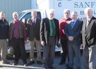 Seth Tramm, the Emergency Services Manager for Clearwater County, Commissioners Dean Newland, John Nelson, Daniel Stenseng, Assessor Allen Paulson, and Commissioners Neal Illies and Arlen Syverson are pictured in front of the new ambulance garage.