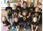The photo includes Dee Dee and some of her “Bear Cubs.” (Standing: Parr, Hallie, Tyden, Dylan, Liv, Caleb, James. Front: Brielle, Elsa, Emma with Dee Dee and Adilee. Missing today: Quincey, Brody, Stella & Kye)