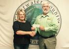 Sharon Dyrdahl~O’Bryan, Club Secretary presenting a check to Harry Hutchens for the Clearwater Veterans Transportation.