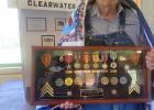 Durwood Lundmark and Army veteran is pictures with a shadow box that was a gift from his son of all his service medals. 


