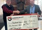 Larry Djernes, on the left, presents the $5,000.00 check to Clearbrook-Gonvick Superintendent Ryan Grow.