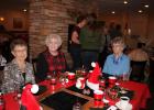 Signe Bergeson, Darlene Sawyer and EvaLee Janssen at one of the decorated tables.