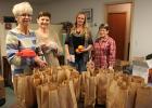 It takes several people to put on Santa Day activities in various towns. Bags that Santa gave out to the children who came to Gonvick were stuffed by Eileen Horn, Jaci Anderson, Stacy Halvorson and Evon Quern. They also did a lot of the planning for the event.