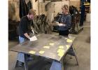 Brody Arlaud and Brynn Hetland straightening the hood.