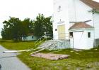 Shingles and siding cover the lawn and road after lightning striked the church.