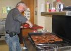 Tim Stebe, a member of the Gonvick Fire Department frying steaks for the Township officers. The meeting was held in the Gonvick American Legion.