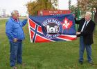 Mayor George Burthwick and Matthew Genova holding the new City of Oklee flag at a ceremony that was held on Friday, September 30th.