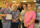 Robin Proffit accepted the School Lunch Hero award at the Clearbrook-Gonvick School with her staff members from Superintendent Wayne Olson and Principal Jeff Burgess. From left to right: Robin, Olson, Kathy Bergman, Burgess, Mandy Knable and Lori Lundell.
