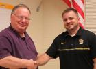 Wayne Olson passing on the responsibilities for the Clearbrook-Gonvick School District to Jeff Burgess.
