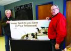 Pete Kjolhaug, manager of North Central Feed Products in Gonvick, wishing Gene Arveson Happy Trails on his retirement.