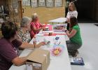 Open class registration was held in the front of the school. Taking entries in were Deb Amiot, Maryanne Lambert, and Barb Swenson. Entering was Jennifer Johnson with the help of her mother Catherine.