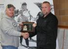 Clearbrook Council members Shawn Johnson and Clearbrook Mayor Dylan Goudge with the Minnesota Softball Hall of Fame Plaque for Michael Gibeau. They are standing in front of the picture of Mike and Senator Hubert Humphrey that was taken by Dick Richards several years ago.