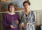 Sheree Breckel and Paulette Kringlen were presented with plaques for their years of service at First National Bank in McIntosh.