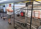 Paul Ruckreigle with the inside frame of the airplane that belongs to Bruce Emmel.