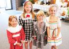 Olivia Basinger, Morgan Basinger, Lainey Fawver and Emma Fawver were very happy to model the dresses made in the 1980’s.