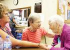 Gail Kotrba and Dorothy Dyrseth visit with Edna McEnelly.
