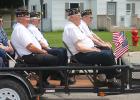  Legionnaire Dick Aos with his Cub Cadet pulled Legionnaires: Norman Rude, Richard Vinje, Bill Rossell, Dean Godtland, Harlow and “Tippy” Berg, Russell Holm, and Kermit Kjolhaug in the Gonvick All-School Reunion and Rodeo parde.