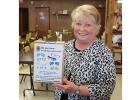 Phyllis Engen is holding the collection box that the Gonvick Lions have placed in the Clearbrook-Leonard Senior Center.