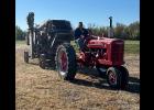 Jarrod Larson driving the Tri River Pioneers M Farmall out to the field for this fall's threshing bee.