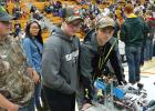 Four members of the RLCC robots team (Austin Erlandson, Angel Auman, Brandon Lee, and Dylan Gustafson) with their robot at the pre-final match check in and inspection.