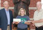 Shown here are Garden Valley Education Foundation Director Vernon Hamnes (right) and Garden Valley Telephone Company CEO/GM Tim Brinkman (left) who recently presented scholarship checks totaling $2,500 to Lydia Lindenfelser.