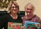 
Tracy Imle and Lyn Schroeder exchange roles on the board of the Clearwater Christmas Project.  They are holding toys that were donated at the Tuesday Study Club’s Tables for Tots, which was held in October.

