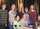 Back row: Gabe Lavine, Amara Churness, Jennifer Lavin, Naomi Shamp, Savanna Rankin, Front Row: Sydney Vakoch, Cassie Faldet, and Danika Harmon who are on stage promoting the silent auction items during their lunch hour for the “We Are Silent” Campaign.
