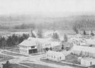 This is an aerial view of Bagley, taken in 1907-1908. The jail is the small white building in the lower right of the photo.