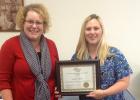 Jill Schewe, Director of Assisted Living, Housing and Home Care for Care Providers of Minnesota presents Christine Wildman a scholarship from the Care Providers of Minnesota Foundation.