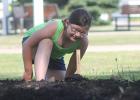 Sam Nordby enjoys checking on the new community garden daily. Her favorite vegetable that’s planted is radishes! The garden is located in the spot of the old cafe.
