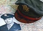 Captain Oscar T. Hanson with the cap that was worn by two airmen.